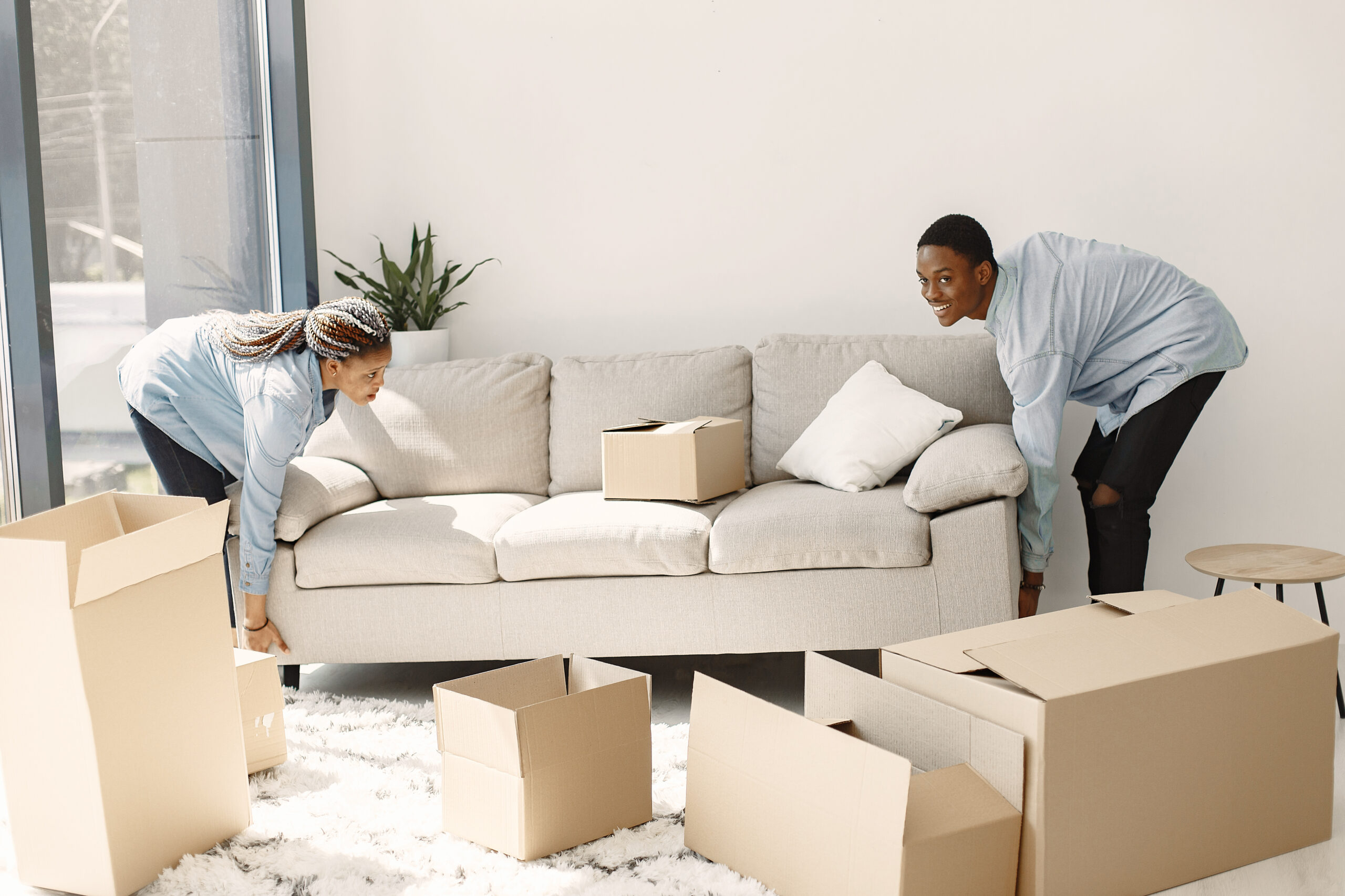young-couple-moving-new-home-together-african-american-couple-with-cardboard-boxes-scaled-1-1-1.jpg